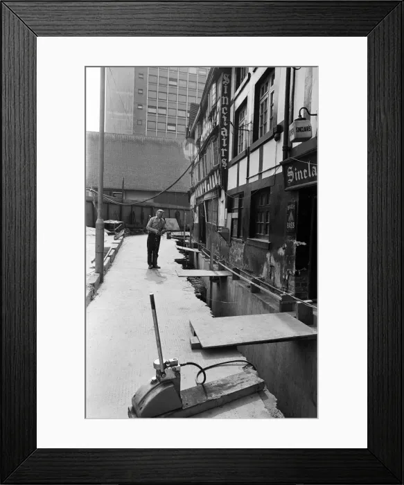 Framed Print : The lifting of the Old Shambles in the centre of Manchester begins with a lift of about Framed Print : The lifting of the Old Shambles in the centre of Manchester begins with a lift of about