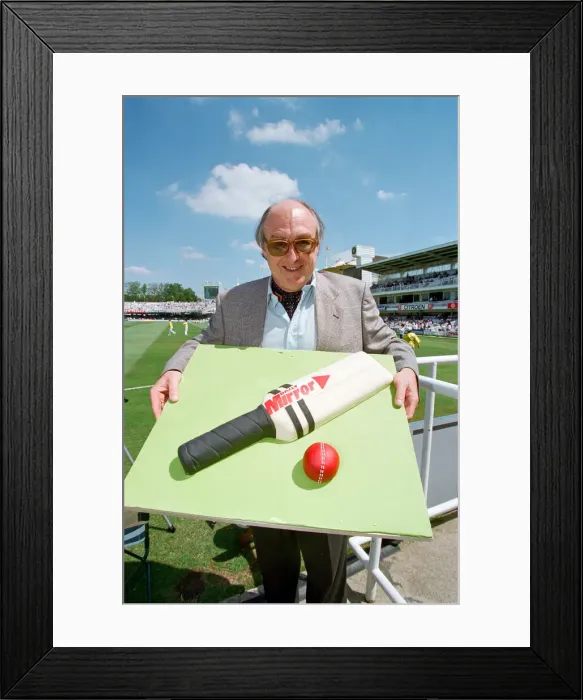 Framed Print : Cricket commentator Henry Blofeld is presented with a Daily Mirror cake in the shape of a Framed Print : Cricket commentator Henry Blofeld is presented with a Daily Mirror cake in the shape of a