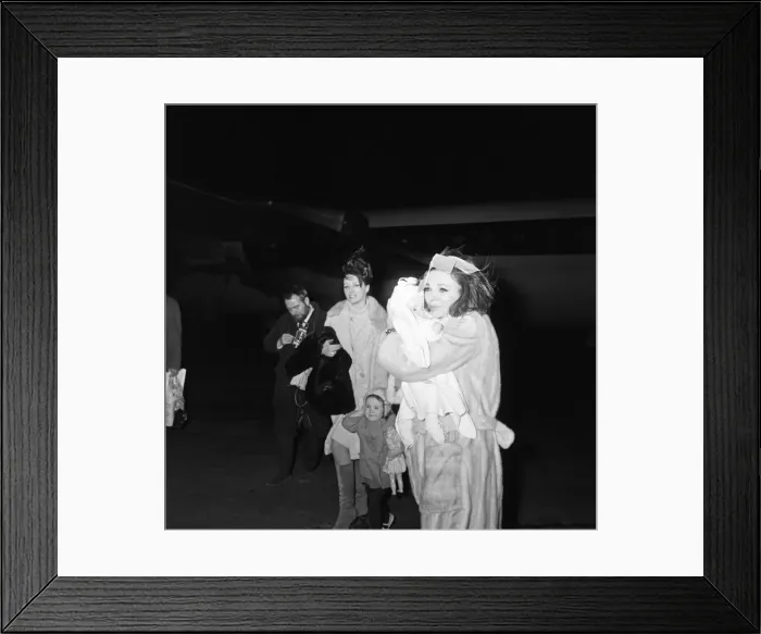Framed Print : Joan Collins arriving by British European Airways from Paris with her daughter Tara