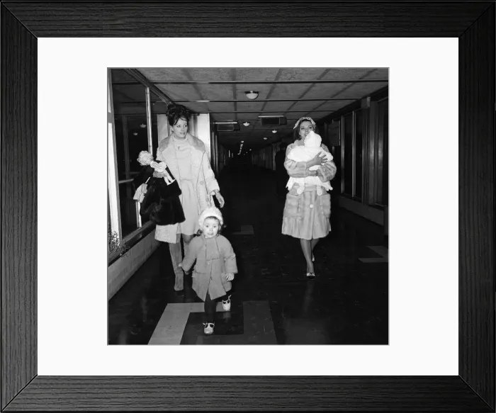 Framed Print : Joan Collins arriving by British European Airways from Paris with her daughter Tara