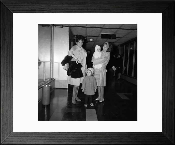 Framed Print : Joan Collins arriving by British European Airways from Paris with her daughter Tara