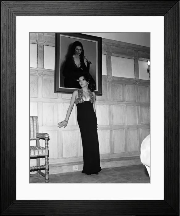 Framed Print : Joan Collins in the Park Street flat she has rented, wearing her favourite evening dress