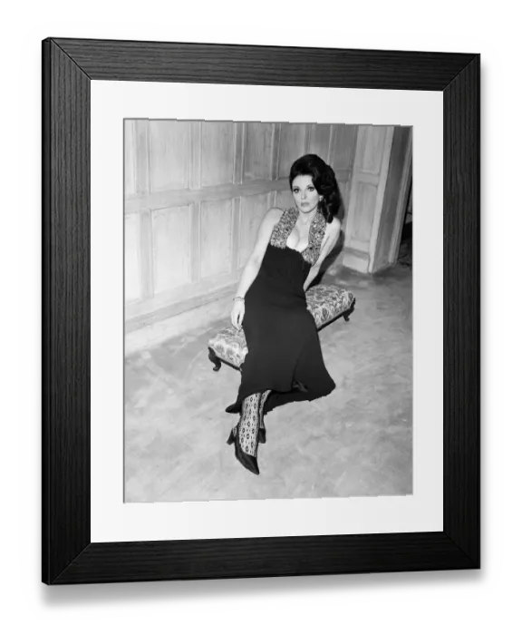 Framed Print : Joan Collins in the Park Street flat she has rented, wearing her favourite evening dress