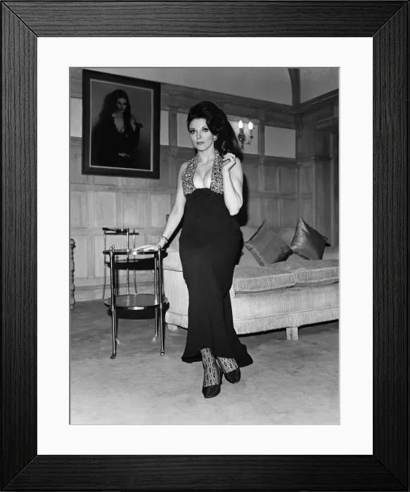 Framed Print : Joan Collins in the Park Street flat she has rented, wearing her favourite evening dress