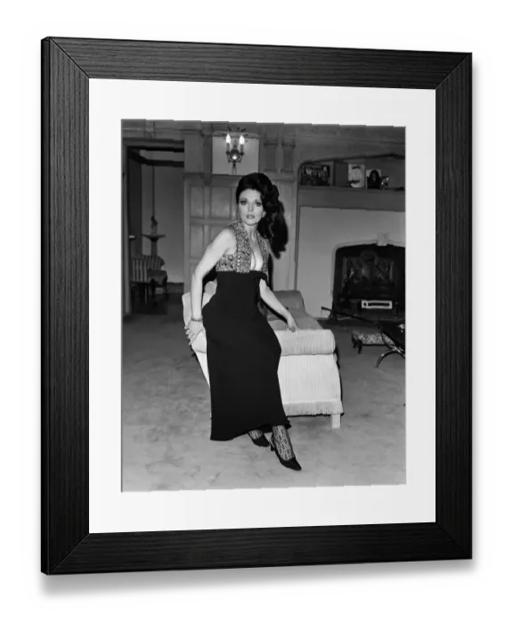 Framed Print : Joan Collins in the Park Street flat she has rented, wearing her favourite evening dress