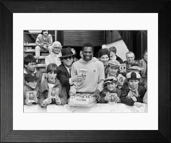 Framed Print : Pop star and Watford FC Chairman, Elton John, handing out Easter eggs to fans Framed Print : Pop star and Watford FC Chairman, Elton John, handing out Easter eggs to fans