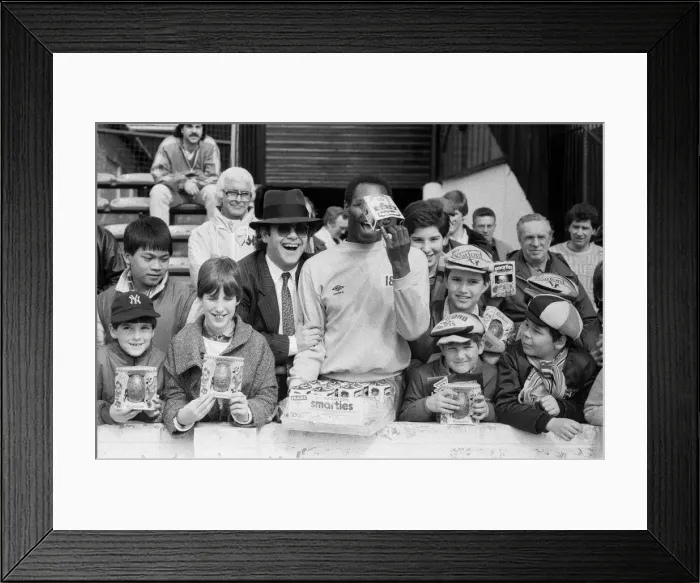 Framed Print : Pop star and Watford FC Chairman, Elton John, handing out Easter eggs to fans