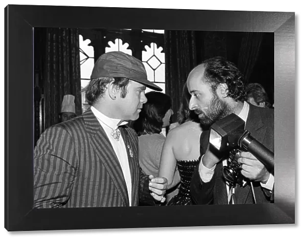 Elton John pictured talking to a photographer at a House of Commons reception