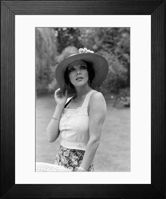 Framed Print : Actress Joan Collins modelling outfits that she will wear on a trip to Tokyo to judge a