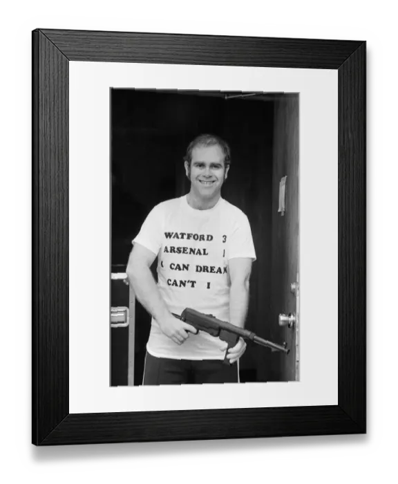 Framed Print : Pop star Elton John, also Chairman of Watford FC, pictured in Los Angeles giving his