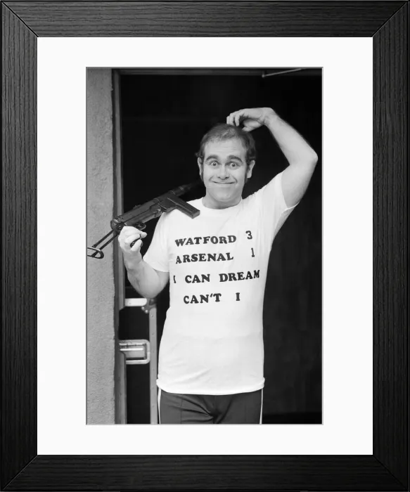 Framed Print : Pop star Elton John, also Chairman of Watford FC, pictured in Los Angeles giving his