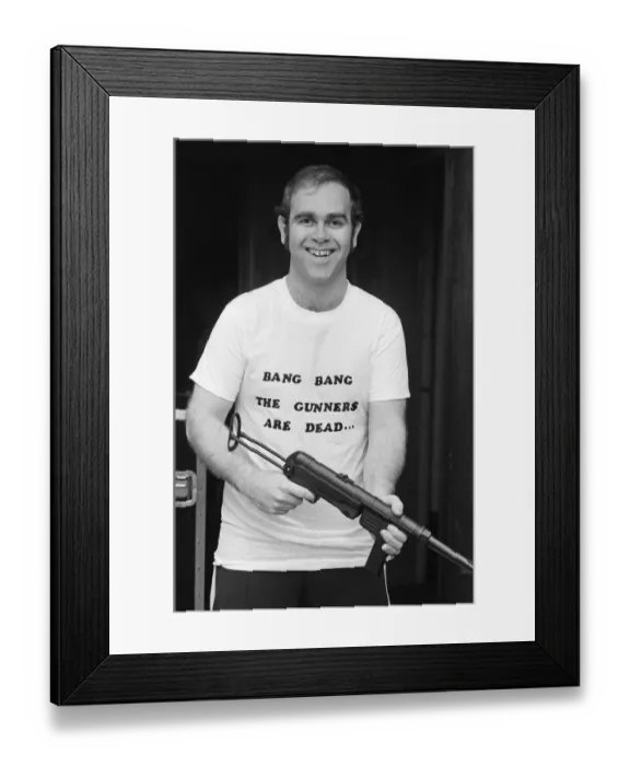 Framed Print : Pop star Elton John, also Chairman of Watford FC, pictured in Los Angeles giving his