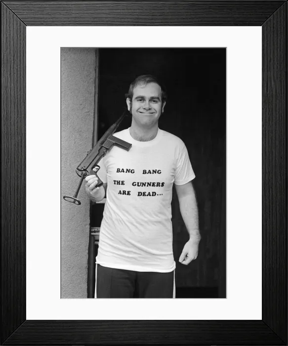 Framed Print : Pop star Elton John, also Chairman of Watford FC, pictured in Los Angeles giving his