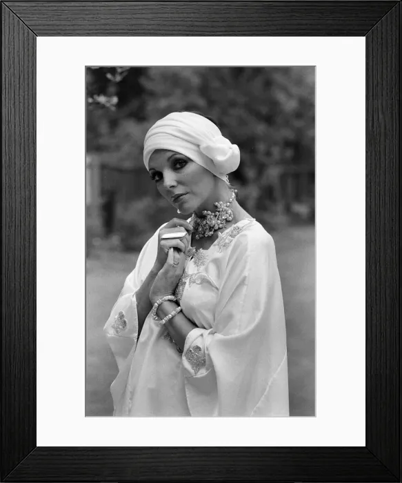 Framed Print : Actress Joan Collins modelling outfits that she will wear on a trip to Tokyo to judge a