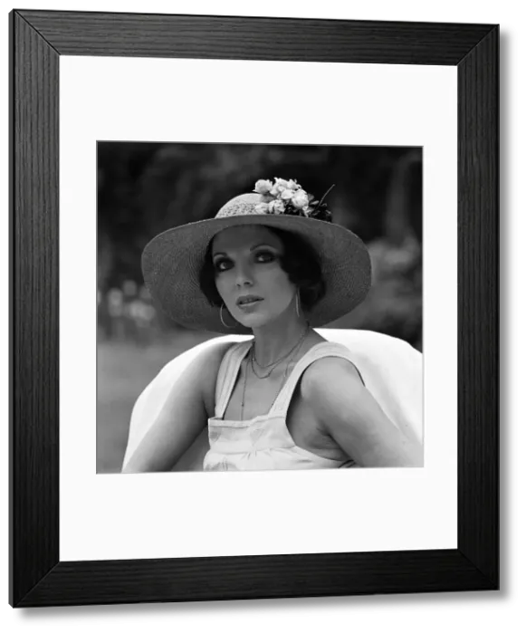 Framed Print : Actress Joan Collins modelling outfits that she will wear on a trip to Tokyo to judge a