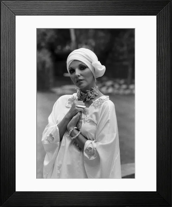 Framed Print : Actress Joan Collins modelling outfits that she will wear on a trip to Tokyo to judge a Framed Print : Actress Joan Collins modelling outfits that she will wear on a trip to Tokyo to judge a