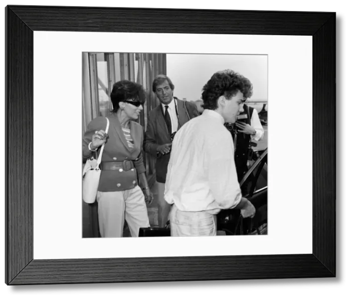 Framed Print : Joan Collins with her son Sacha, 17, arriving at Heathrow from Los Angeles Framed Print : Joan Collins with her son Sacha, 17, arriving at Heathrow from Los Angeles
