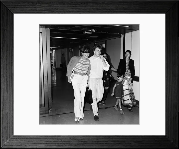 Framed Print : Joan Collins with her son Sacha, 17, arriving at Heathrow from Los Angeles