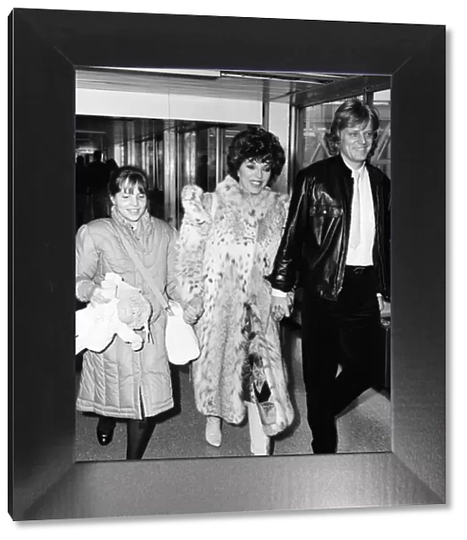 Joan Collins with daughter Katyana Kass and boyfriend Peter Holm at Heathrow after