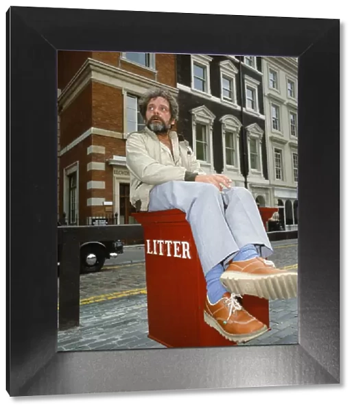 Actor David Jason pictured in Covent Garden, London, sitting on a litter bin. July 1985