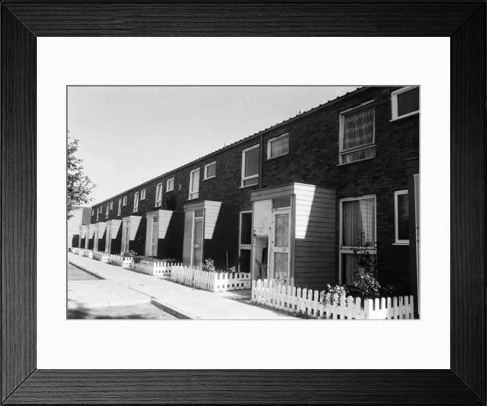 Framed Print : Painted council houses and the unpainted ones - part of a battle of home buying at a Framed Print : Painted council houses and the unpainted ones - part of a battle of home buying at a