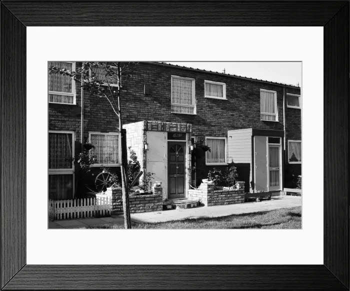 Framed Print : Painted council houses and the unpainted ones - part of a battle of home buying at a