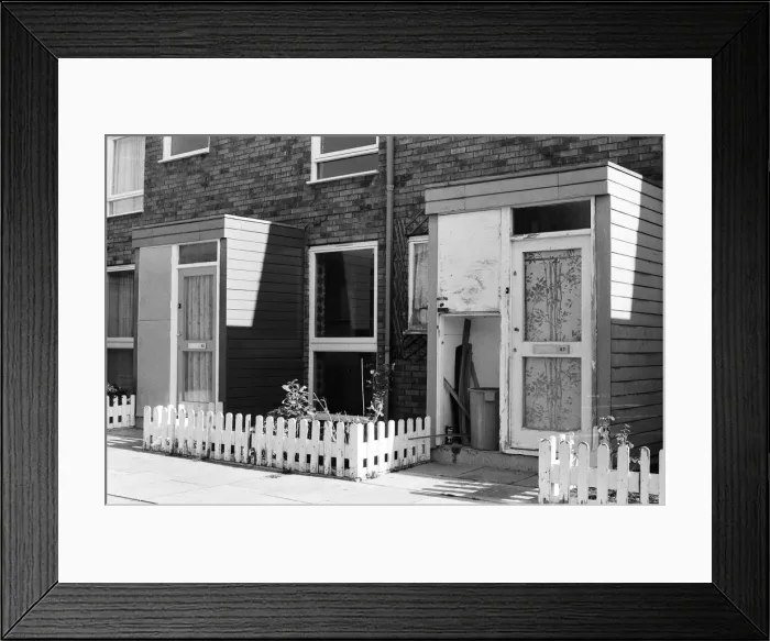 Framed Print : Painted council houses and the unpainted ones - part of a battle of home buying at a Framed Print : Painted council houses and the unpainted ones - part of a battle of home buying at a