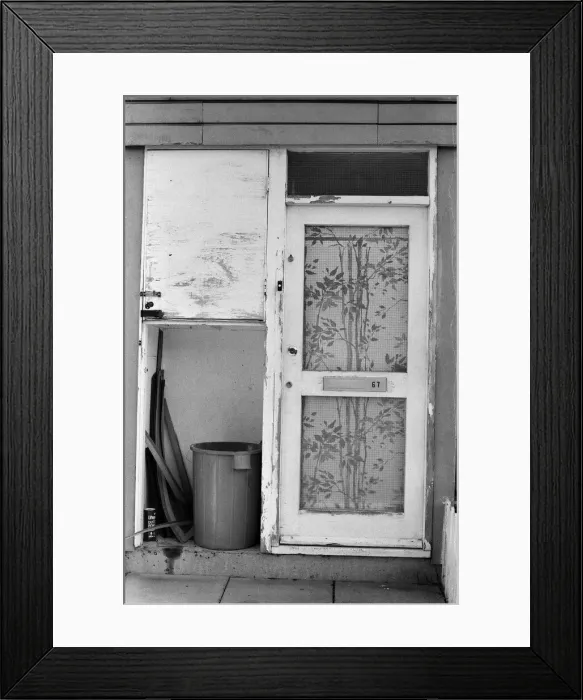 Framed Print : Painted council houses and the unpainted ones - part of a battle of home buying at a Framed Print : Painted council houses and the unpainted ones - part of a battle of home buying at a
