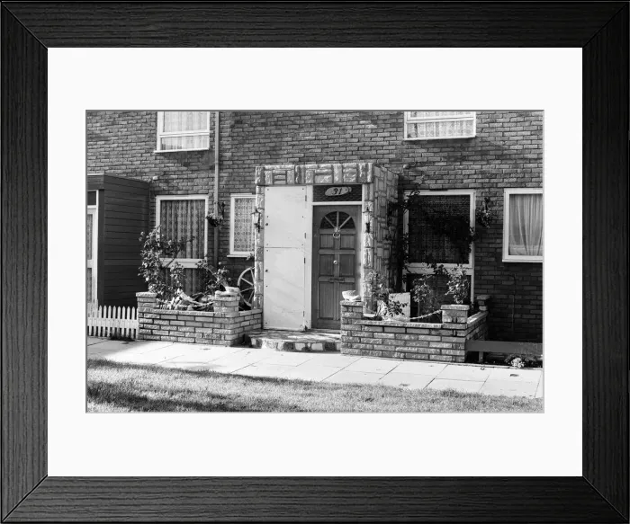 Framed Print : Painted council houses and the unpainted ones - part of a battle of home buying at a Framed Print : Painted council houses and the unpainted ones - part of a battle of home buying at a