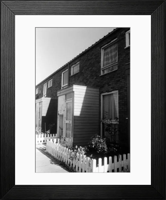 Framed Print : Painted council houses and the unpainted ones - part of a battle of home buying at a Framed Print : Painted council houses and the unpainted ones - part of a battle of home buying at a