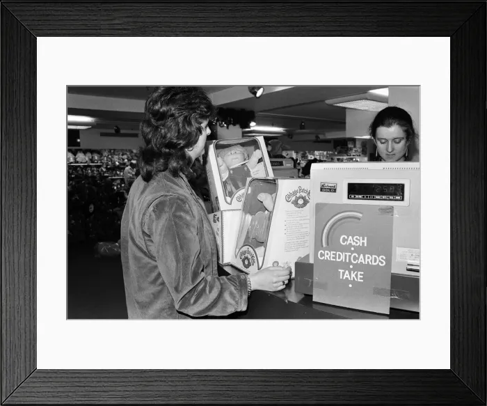 Framed Print : Cabbage Patch Dolls for sale in Harrods. One lucky customer buying two cabbage patch