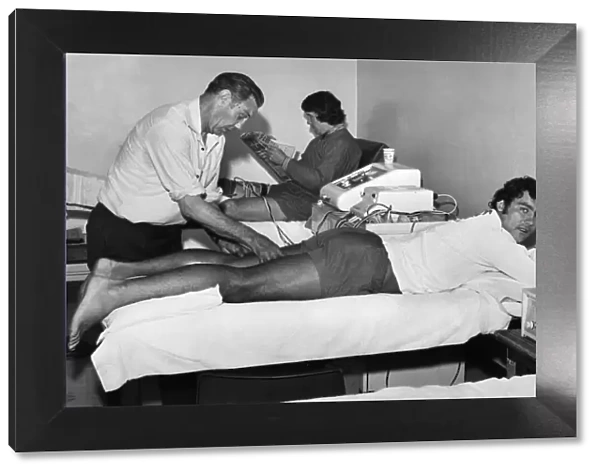 Liverpool trainer Joe Fagan helps injured player Ray Kennedy back to fitness while Chris