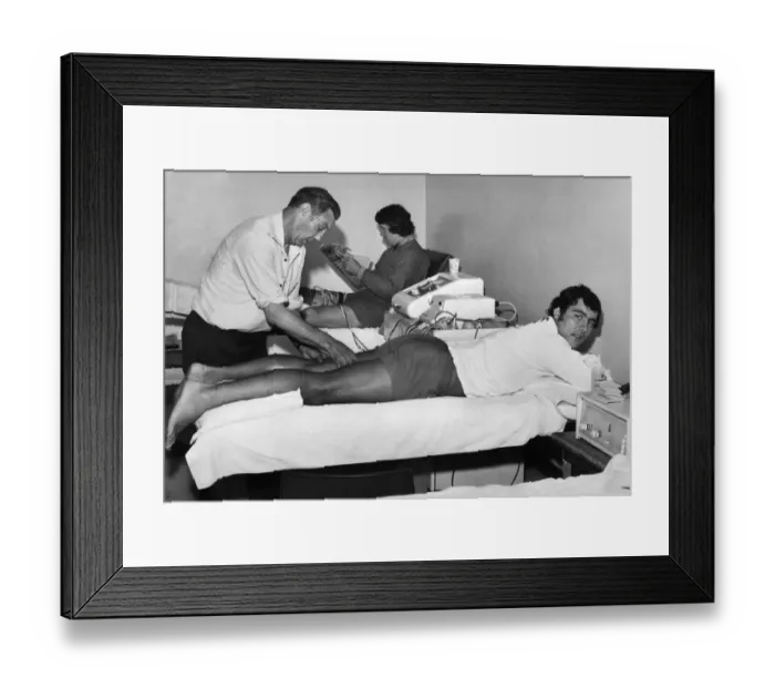 Framed Print : Liverpool trainer Joe Fagan helps injured player Ray Kennedy back to fitness while Chris