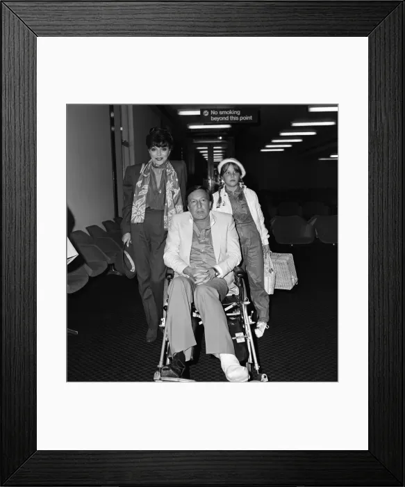 Framed Print : Joan Collins with husband Ron Kass and daughter Katyana arriving at Heathrow from Los