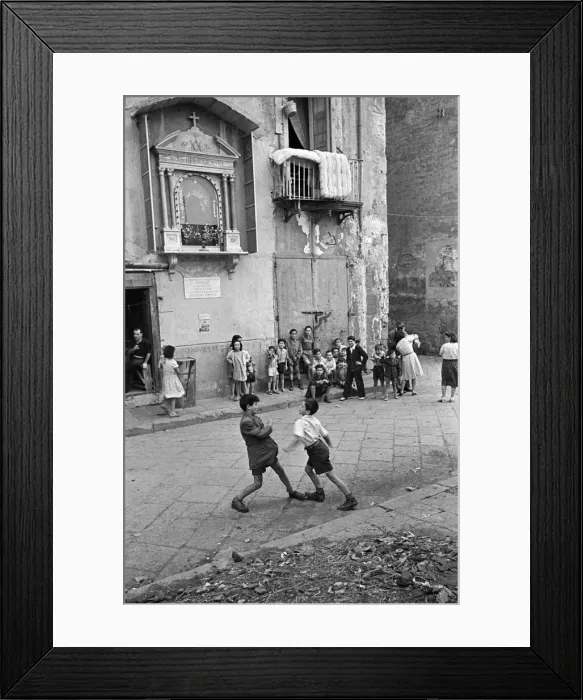 Framed Print : Scenes in Naples, southern Italy showing young boys entertaining themselves