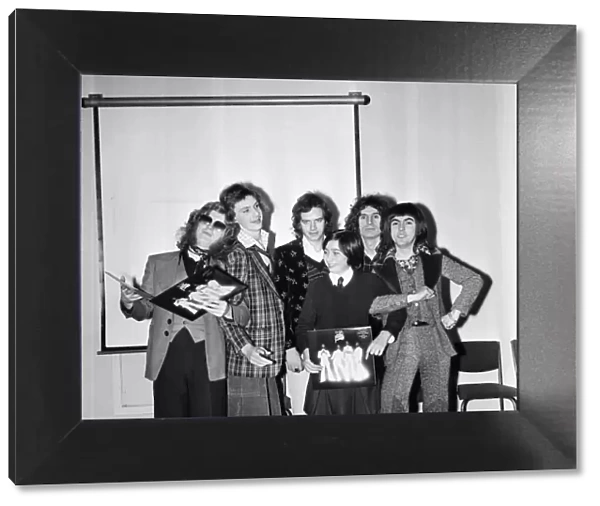 Slade (l-r Noddy Holder, Jim Lea, Don Powell and Dave Hill) pictured with prize winners