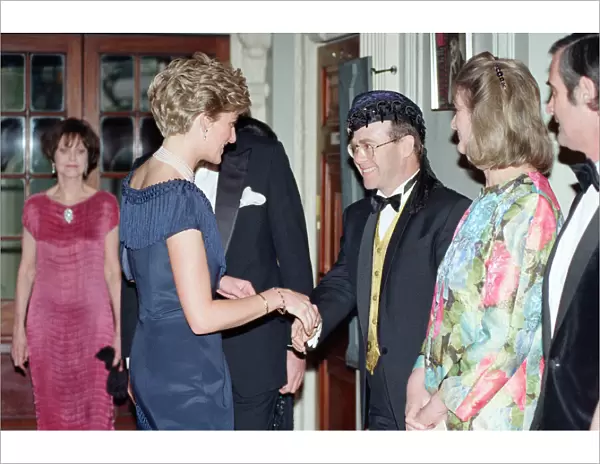 HRH Princess Diana, Princess of Wales is greeted by singer Elton John for a charity
