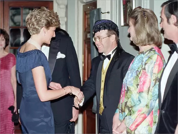 HRH Princess Diana, Princess of Wales is greeted by singer Elton John for a charity