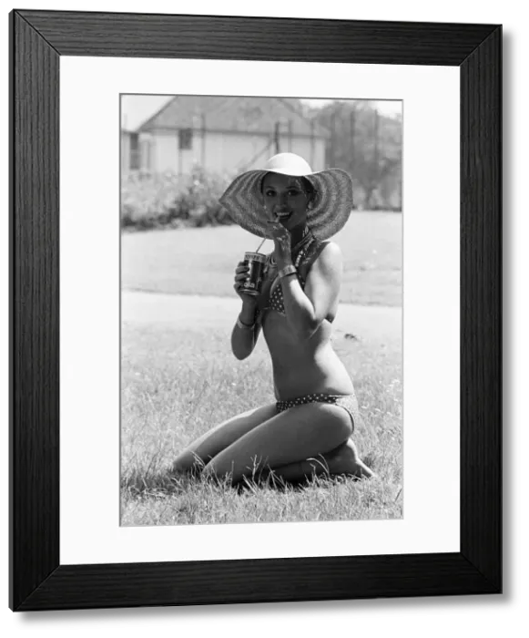 Framed Print : Young lady cools down with a refreshment as she enjoys the summer heatwave, Teesside Framed Print : Young lady cools down with a refreshment as she enjoys the summer heatwave, Teesside