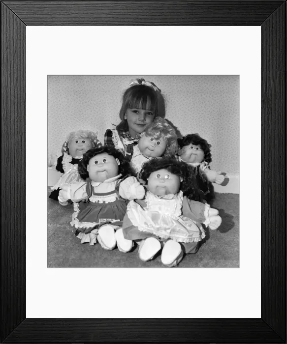 Framed Print : A young girl plays with her Cabbage Patch Dolls. 5th November 1987 Framed Print : A young girl plays with her Cabbage Patch Dolls. 5th November 1987