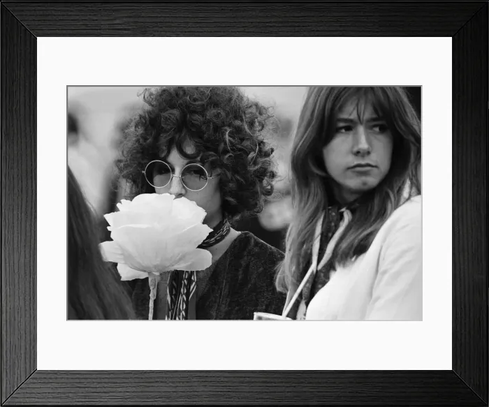 Framed Print : A young couple of females, with large flower and fashionable sunglasses at The Windsor