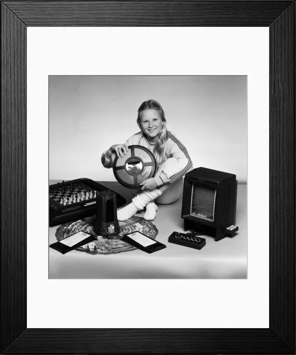Framed Print : A young girl with a selection of childrens toys. 11th November 1983 Framed Print : A young girl with a selection of childrens toys. 11th November 1983