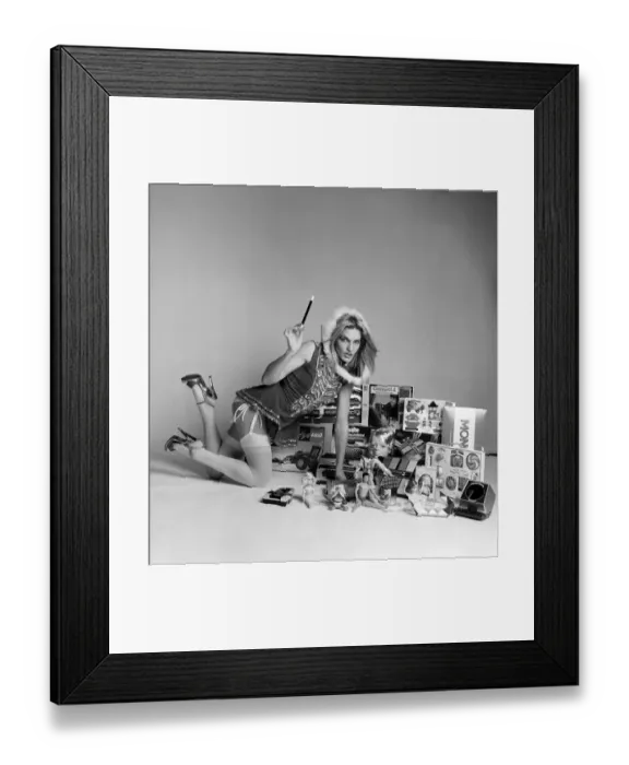 Framed Print : A female model in a santa outfit with a selection of childrens toys for Christmas Framed Print : A female model in a santa outfit with a selection of childrens toys for Christmas