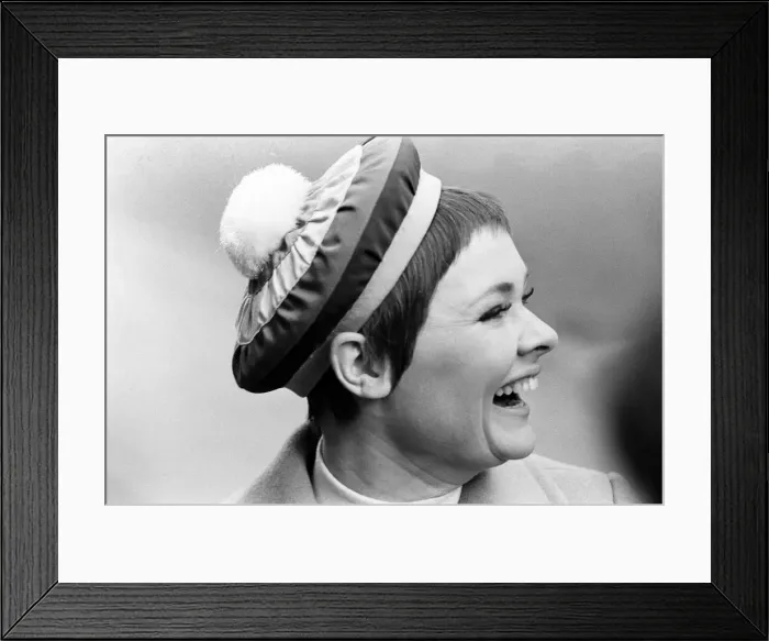 Framed Print : Judi Dench being photographed by the press wearing a Christian Dior beret called Framed Print : Judi Dench being photographed by the press wearing a Christian Dior beret called