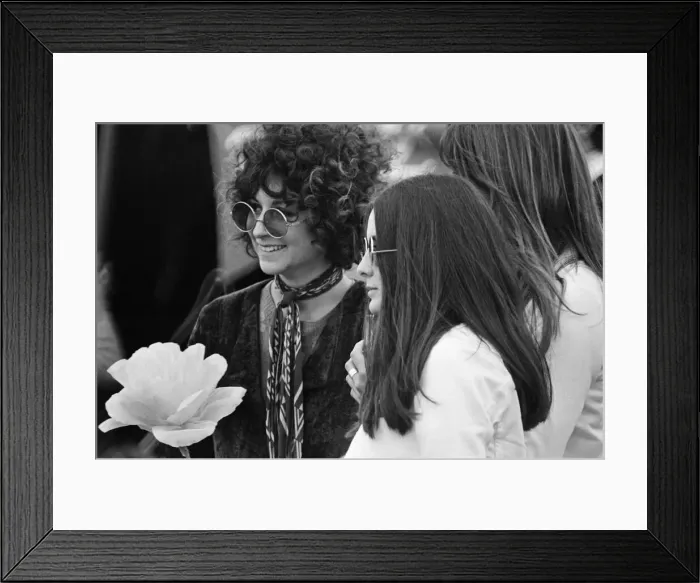 Framed Print : A young couple, with large flower and fashionable sunglasses at The Windsor Jazz Festival Framed Print : A young couple, with large flower and fashionable sunglasses at The Windsor Jazz Festival