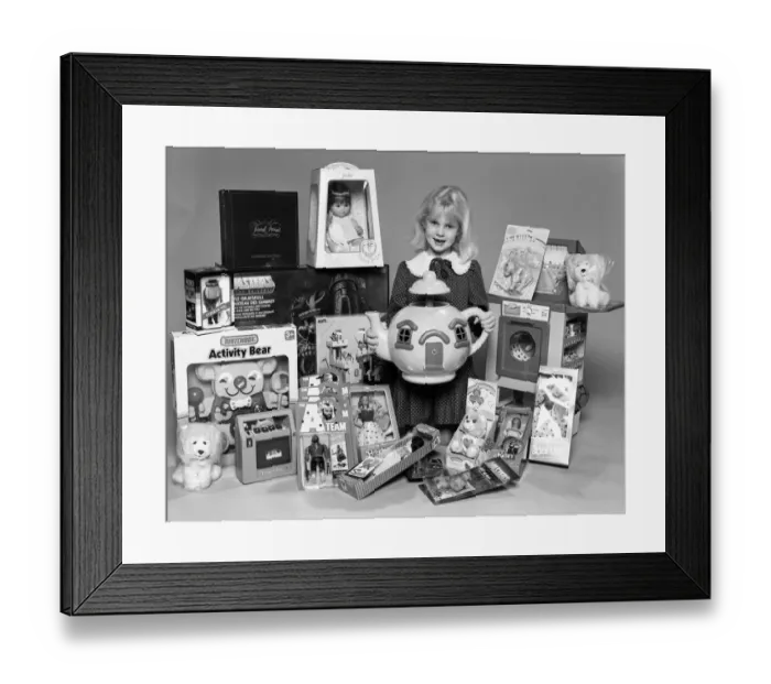 Framed Print : A young girl with a selection of childrens toys for Christmas. 6th December 1984