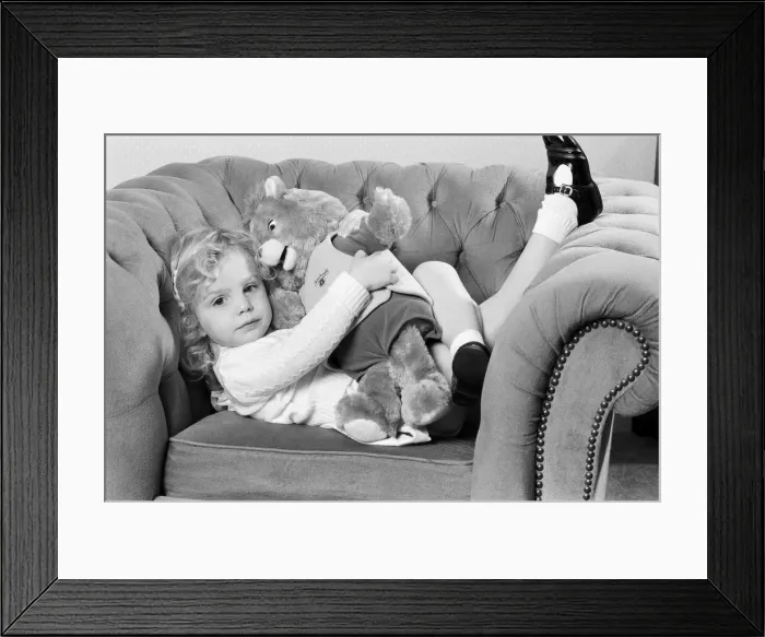Framed Print : A young girl with a Teddy Ruxpin toy. 21st October 1986