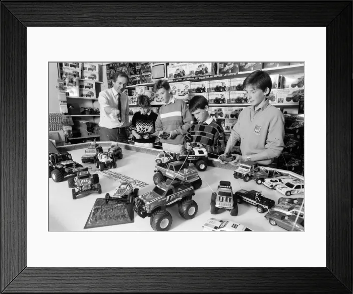 Framed Print : Young boys playing with toy remote control cars in Hamley s, London Framed Print : Young boys playing with toy remote control cars in Hamley s, London