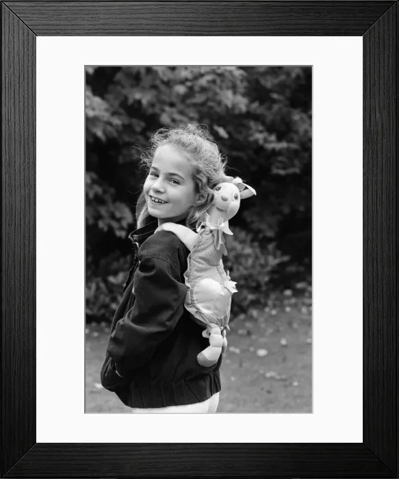 Framed Print : A young girl wearing a soft toy rucksack. 21st October 1986 Framed Print : A young girl wearing a soft toy rucksack. 21st October 1986