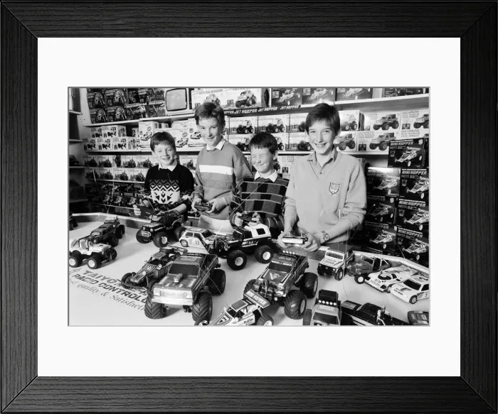 Framed Print : Young boys playing with toy remote control cars in Hamley s, London Framed Print : Young boys playing with toy remote control cars in Hamley s, London